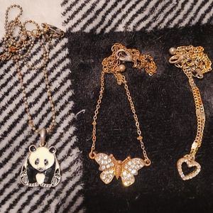 2 bronze necklaces 1 heart 1 butterfly and a black chain panda bear